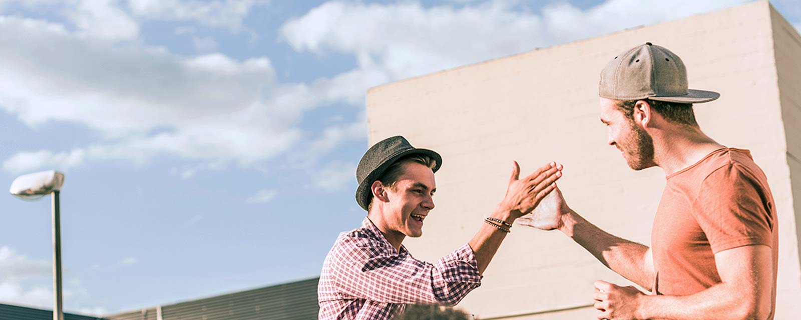 Two young guys high-fiving